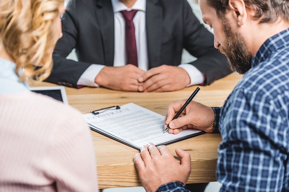 Personal injury attorney reviewing and signing legal documents with a client in Florida and Georgia – DuFault Law provides trusted legal representation.