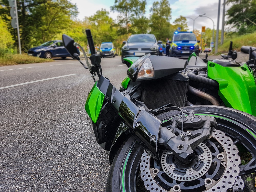 Motorcycle accident on Florida highway involving lane splitting and car collision, used by DuFault Law personal injury attorneys.